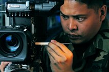 YOKOTA AIR BASE, Japan -- Staff Sgt. Michael Santiago adjusts a circuit board on a video camera during an inspection.  He is a broadcast maintainer from Air Force News Agency's Operating Location-C here.  They maintain equipment for American Forces Network-Tokyo and other Air Force broadcast detachments in the area.  (U.S. Air Force photo by Master Sgt. Val Gempis)