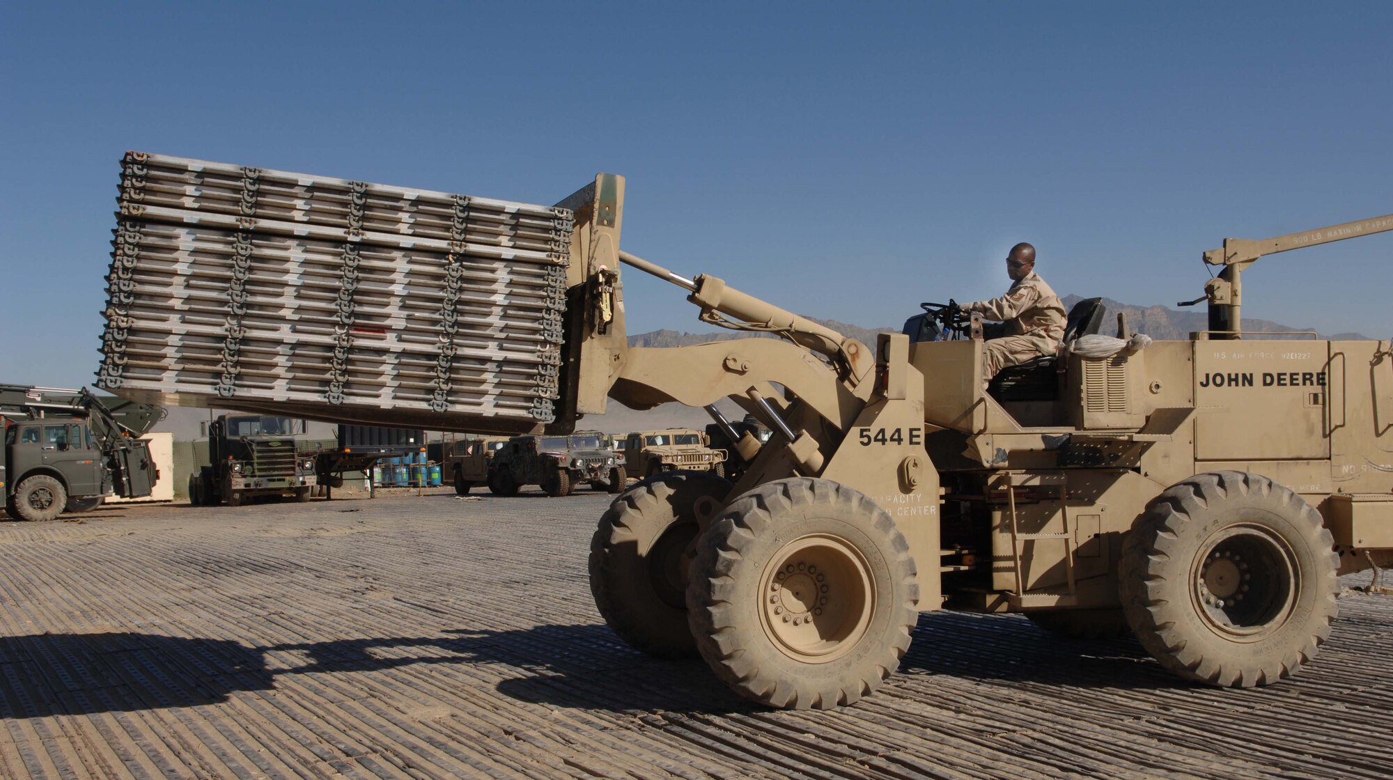 BAGRAM AIR BASE, Afghanistan -- Tech. Sgt. Milton Spivey moves pallets to the logistics storage yard for redistribution.  Airmen from the 455th Expeditionary Logistics Readiness Squadron collected and returned 2,417 pallets and 4,489 net sets in three months.  (U.S. Air Force photo by Capt. Mark D. Gibson)