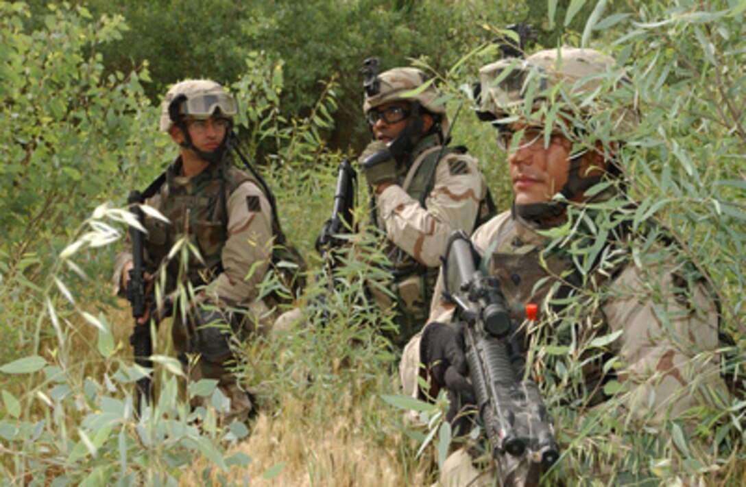 Soldiers from the 2nd Platoon, Bravo Company, 2nd Battalion, 69th Armor Regiment conduct a search for insurgents around the western side of the Diyala River in Baquba, Iraq, on April 20, 2005. 