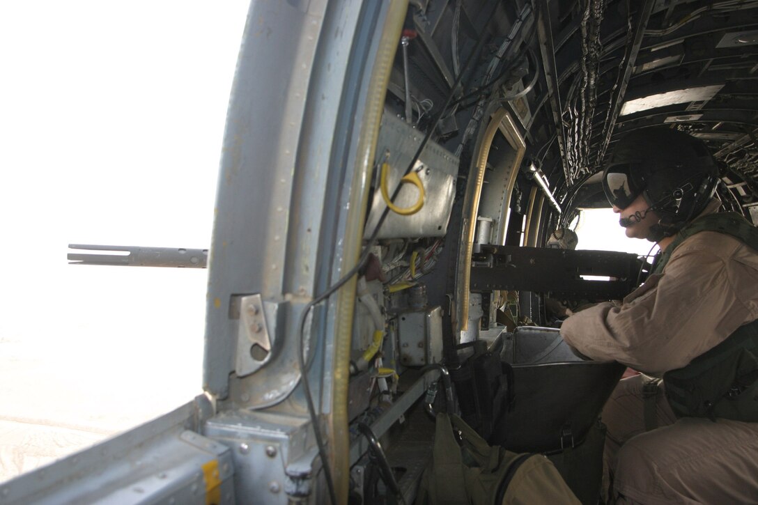 AL TAQADDUM, Iraq -- Sgt. Jesus Garcia, a CH-46E crew chief with Marine Medium Helicopter Squadron 364 scans the ground while his aircraft cruises toward another casualty evacuation, May 24. The Purple Foxes have been deployed here since May 1 and are scheduled to return home to Camp Pendleton, Calif., in September.