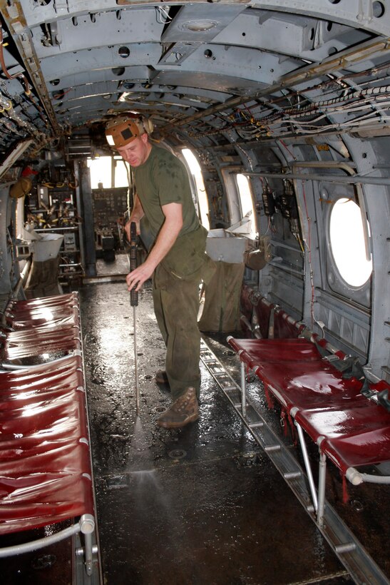 AL ASAD, Iraq ? Cpl. Chad W. Roberts, a crewchief with Marine Medium Helicopter Squadron 764 and Kuna, Idaho, native, pressure washes the floorboards in a CH-46E to prevent corrosion May 24.  The squadron, based at Edwards Air Force Base, Calif., is on its second tour in Iraq since their activation to support Operation Iraqi Freedom in 2004.