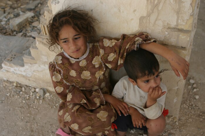 CAMP TAQADDUM, Iraq (May 28, 2005) - An Iraqi girl and her brother sit and watch as the Soldiers with 3rd platoon, Alpha Company, 2nd Battalion, 112th Armor, 36th Infantry Division, distributed more than 225 pairs of shoes to the families in Al Kabani May 25.