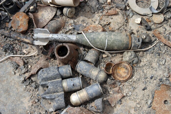 CAMP TAQADDUM, Iraq -- Unexploded ordnance from a bunker in the Ammunition Supply Point lay scattered after insurgents landed a rocket within the confines of the ASP last year.  ::n::“It was pretty amazing because two containers of ammunition are still unaccounted for,” Staff Sgt. Shaun Adams, staff noncommissioned officer in charge of the Ammunition Supply Point. “They literally melted to the ground because everything was so hot. Parts of another ISO container ended up on the other side of the berm. [Explosive Ordnance Disposal] teams come out here regularly to help clean this place up.”