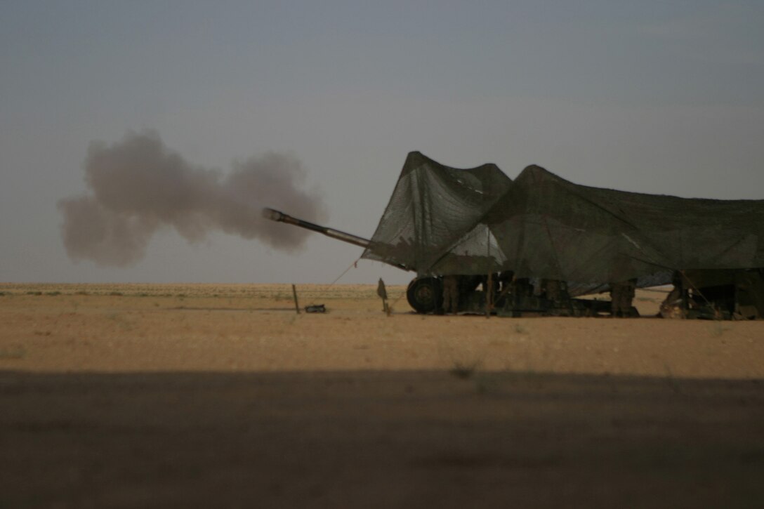 Marines of 1st gun India battery, 3rd battalion 10th Marines, attached to the Battalion Landing Team 2nd Bn, 8th Marines, 26th Marine Expeditionary Unit (Special Operations Capable), fire a 198 towed howitzer May 23 at Udairi Range, gun point PA03, Camp Buehring, Kuwait.  As the theatre reserve, for Central Command, Marines of the 26th MEU (SOC) are conducting live fire exercises at Udairi Range, near Camp Buehring, Kuwait in preparation for potential follow-on missions in the region. (USMC photo by LCpl. Daniel R. Lowndes) (Released)