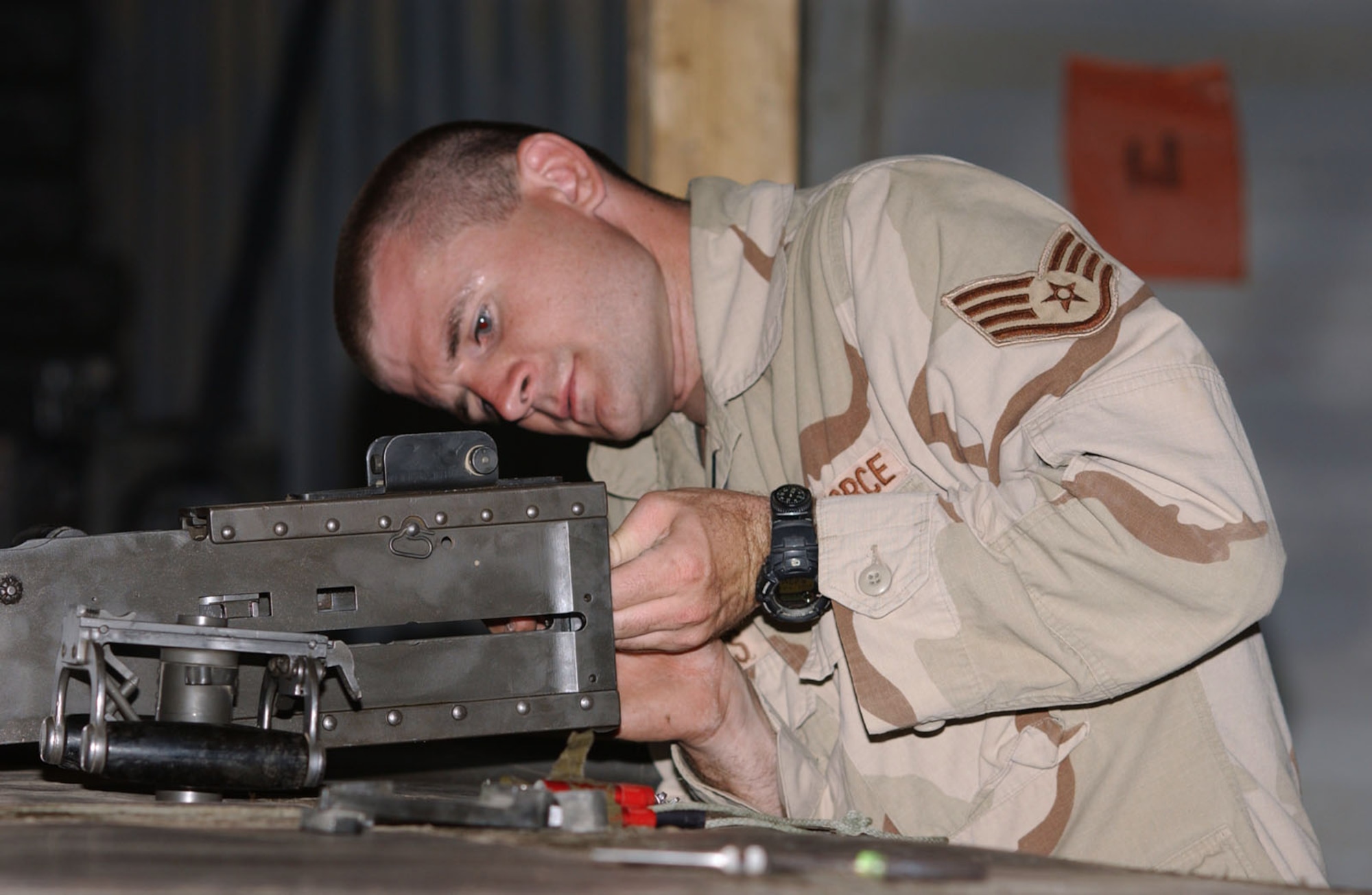 BALAD AIR BASE, Iraq -- Staff Sgt. Ivan Ochoa finishes mounting a .50-caliber machine gun and completes his final inspections before a convoy.  His unit provides convoy protection to civilian contractors and Army units delivering supplies throughout the area of responsibility.  He is a assigned to the 732nd Expeditionary Mission Support Group's Detachment 2632.  (U.S. Air Force photo by Staff Sgt. Lindsey Maurice)                      