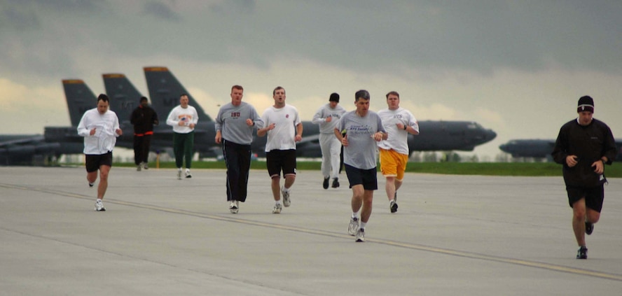 MINOT AIR FORCE BASE, N.D. -- Airmen from across the base run past several B-52 Stratofortresses during a fun run on the runway here May 26.  The runway is shut down until June 5 for maintenance.  (U.S. Air Force photo by Airman 1st Class Danny Monahan)