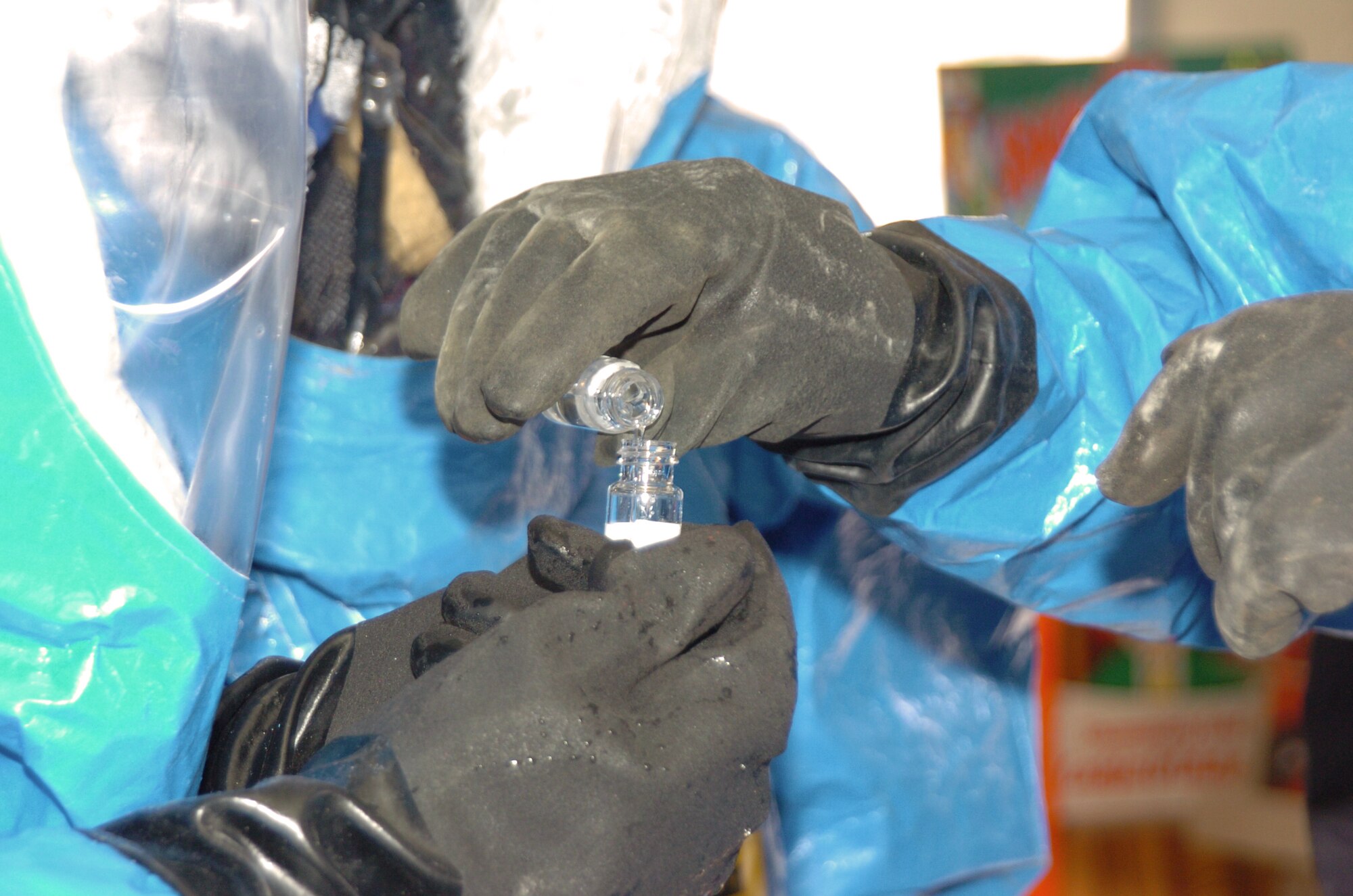 DUGWAY, Utah -- Members of the 61st Weapons of Mass Destruction Civil Support Team prepare a sample for testing during an exercise here.  In the event of an attack or incident involving chemical, biological or radiological agents, nuclear hazards or high-yield explosives, guardsmen with the Arkansas-based team respond to, advise and assist local and regional authorities.  (Department of Defense photo by Brandie Mikesell)