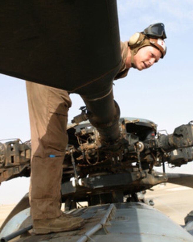 U.S. Marine Sgt. Timothy Hale performs a preflight inspection on a CH-53 Super Stallion helicopter prior to flying a mission over Iraq on May 17, 2005. Hale is a CH-53 crew chief and is attached to Marine Heavy Lift Squadron 465, which is currently forward deployed to Al Asad, Iraq. 