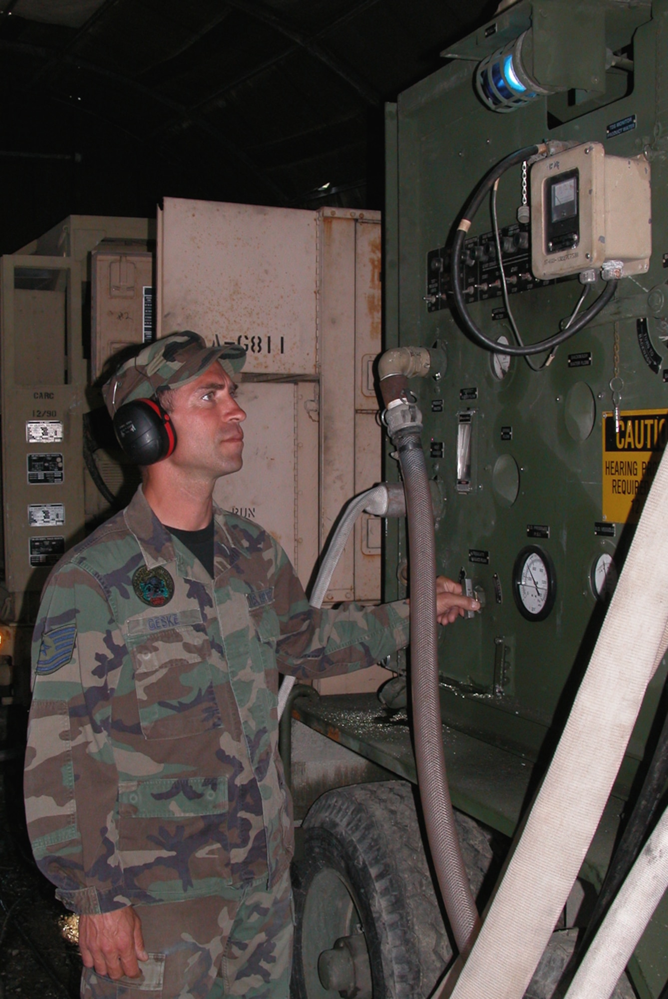 CAMP WY-WUH, Alaska -- Tech. Sgt. Brian Geske checks pressure gauges and production flow on a reverse osmosis water purification unit.  The unit purifies the water from a local stream and then pumps it into storage bladders for camp use.  Sergeant Geske is deployed here supporting Operation Alaskan Road from the Kansas Air National Guard's 190th Civil Engineer Squadron.  (U.S. Air Force photo by Maj. Richard Sater)