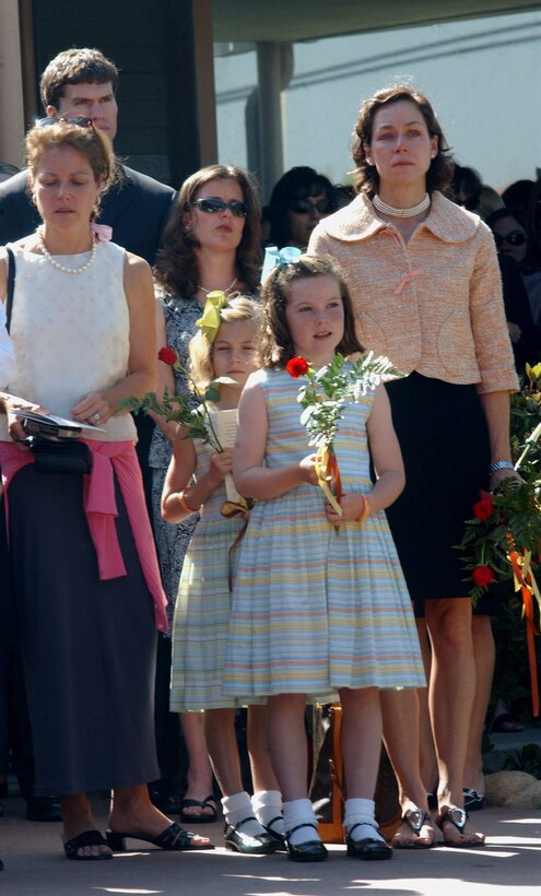 Two of Lt. Col. John C. Spahr's sisters, Sabrina S. Lawrence (left) and Tracy S. Harrington (far right) and his nephews, Kelly and Grace stand outside a memorial service May 26 in honor of Spahr and Capt. Kelly C. Hinz. Both pilots died in a recent aircraft incident in support of Operation Iraqi Freedom last month. Photo by Cpl. Skye Jones