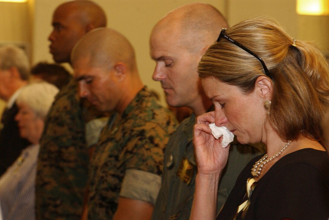 Guests mourned as they honored two Marine pilots killed in a recent aircraft mishap at a memorial service May 26. Lt. Col. John C. Spahr and  Capt. Kelly C. Hinz were loved by many and the station chapel was overfilled with visitors wishing to pay their respects. Photo by Cpl. Skye Jones