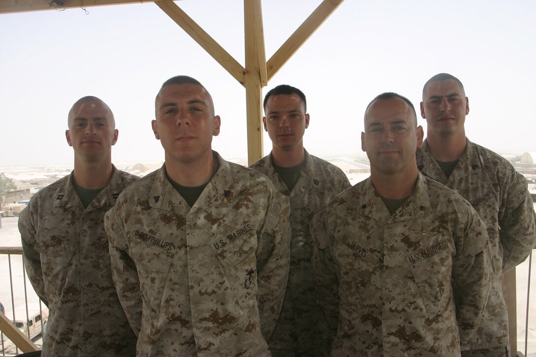 AL TAQADDUM, Iraq ? The Al Taqaddum air boss shop, (back row L-R) Capt. Donald Meek, assistant air boss; Staff Sgt. Dick Maxie, the flight clearance staff noncommissioned officer; Sgt. Nicholas Breidenger, the air boss chief. (front row L-R) Cpl. Anthony Riley, air boss clerk and Lt. Col. Allan Jarvis, air boss; are responsible for all flight operations in and out of Al Taqaddum. The air boss Marines have coordinated 167 CASEVAC missions, transferring more than 270 patients in their three months here.