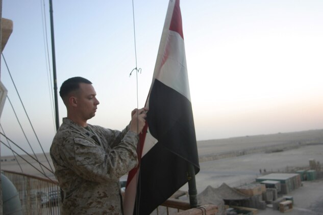 Staff Sgt. Richard Maxie, the flight clearance staff noncommissioned officer takes down the Iraqi flag at the end of the day here. Maxie, a Gibbstown, N.J., native, is responsible for all of the requests for any aircraft wanting to use the airfield that does not have prior permission.