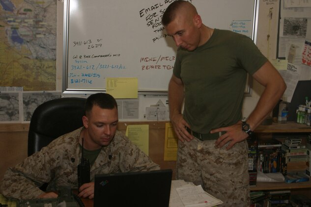 Staff Sgt. Richard Maxie, the flight clearance staff noncommissioned officer and Cpl. Anthony Riley, air boss clerk work to organize the ?milk? run. The ?milk? run takes routine patients to the proper medical facility for needed treatment.