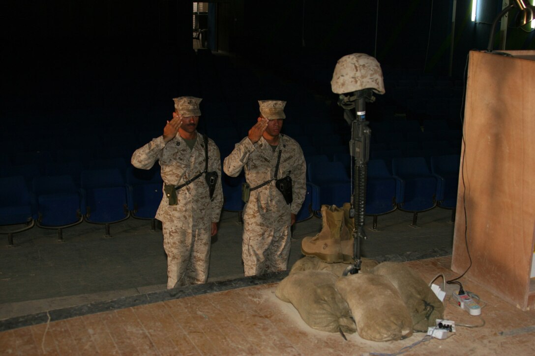 AL ASAD, Iraq - Two Marines show their final respects to a great Marine, First Sgt. Michael S. Barnhill of 6th Engineer Support Battalion. Barnhill was honored with a memorial service held on Memorial Day here.