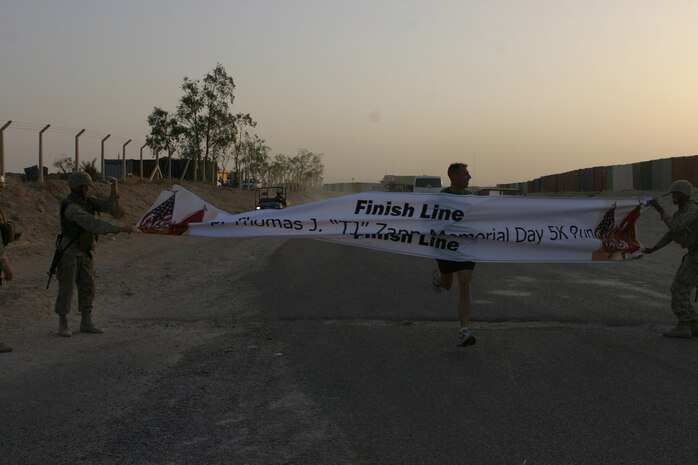 CAMP TAQADDUM, Iraq (May 30, 2005) - Major Michael J. Murchison, a Detroit native and the operations officer for the Supply Management Unit, Combat Logistics Regiment 25, 2d Force Service Support Group (Forward), finishes the 5 kilometer Memorial Day run first with a time of 18 minutes and eight seconds. The run was to honor the sacrifices of Lance Cpl. Thomas J. Zapp, the first Marine with 2d Supply Battalion to lose his life during Operation Iraqi Freedom, and all those who have made the ultimate sacrifice.