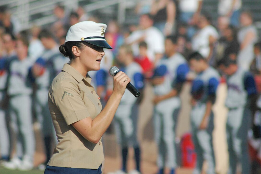 Pfc. Emily Sample, temporary additional duty clerk, Headquarters and Headquarters Squadron, sings the national anthem to kick off the first regular season home game for the Yuma Scorpions on Memorial Day May 30. The Scorpions' ball club offered active duty and retired military members specials for opening day and will continue to offer them throughout the season.