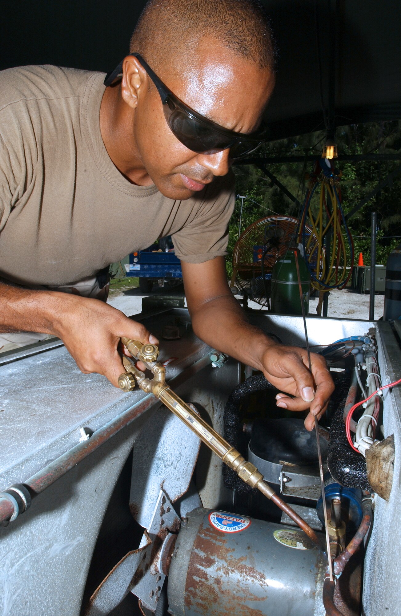 OPERATION ENDURING FREEDOM -- Staff Sgt. Jose Concepion repairs an environmental control unit used to cool tents at a forward-deployed location.  He is assigned to the 40th Expeditionary Civil Engineer Squadron's heating, ventilation, air conditioning and refrigeration flight and is deployed from Muniz Air National Guard Base, Puerto Rico.  (U.S. Air Force photo by Staff Sgt. Joceyln Rich)