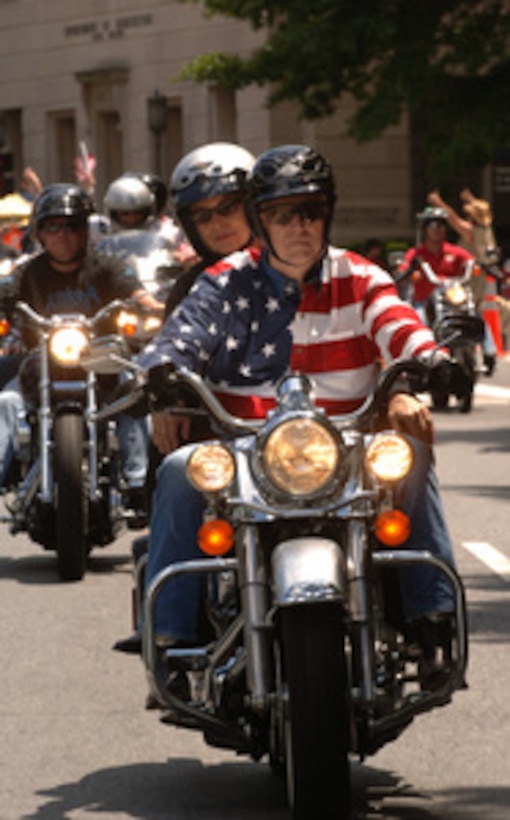 Chairman of the Joint Chiefs of Staff Gen. Richard B. Myers, U.S. Air Force, and his wife Mary Jo lead thousands of motorcyclists through ride through Washington, D.C., as they take part in Rolling Thunder XVIII on May 29, 2005. The annual motorcycle ride is meant to bring attention to POW/MIA issues and the fact that many American service members from past wars are still unaccounted for. 