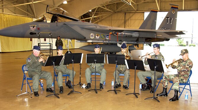 TYNDALL AIR FORCE BASE, Fla. -- The Brass Band plays at the 325th Operations Group change of command ceremony recently. The band members are (from left) Maj. John Evans, Capt. Lee Wilstead, Maj. Raymond Law, 2nd Lt. Steven Vega, Capt. Chris Comer and Airman 1st Class Brandon Schessl.  (U.S. Air Force photo)