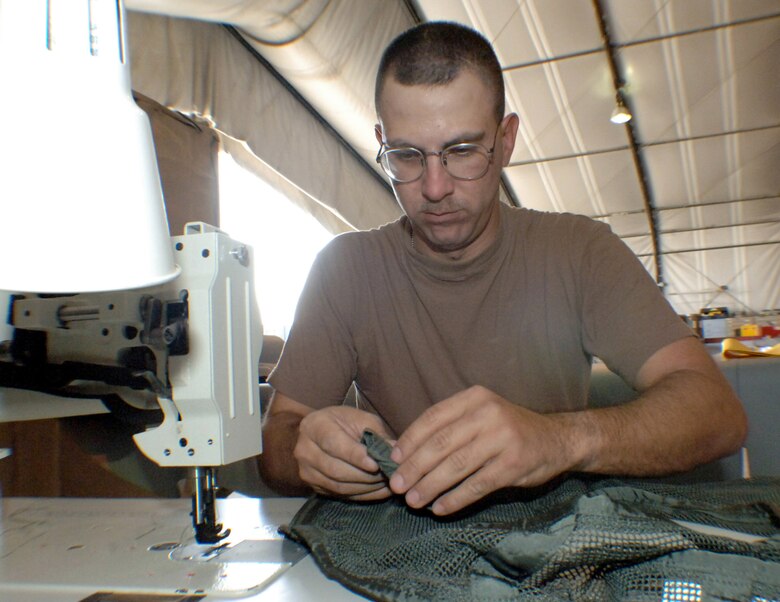 BAGRAM AIR BASE, Afghanistan (AFPN) -- Staff Sgt. Andrew Topor assembles an aircrew survival vest. Sergeant Topor, a survival equipment supervisor/rigger, is deployed here from Davis-Monthan Air Force Base, Ariz. (U.S. Air Force photo by Capt. James H. Cunningham) (Released)