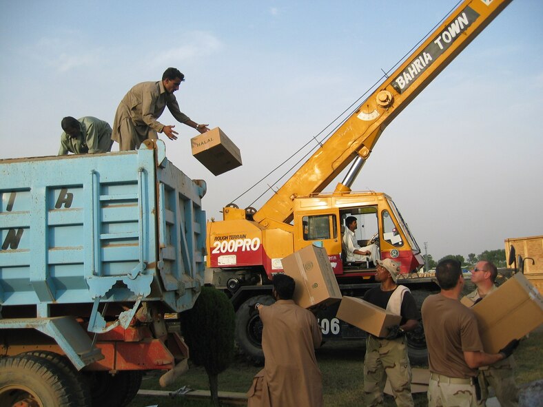 PAKISTAN (AMCNS) – Members of the 818th Contingency Response Group help Pakistanis load daily food rations into a truck bound for areas affected by the recent earthquake. The 818th CRG deployed to Pakistan from McGuire Air Force Base, N.J., to accept and help distribute U.S. humanitarian aid sent to the country. (Photo by 1ST Lt. Erick Saks)