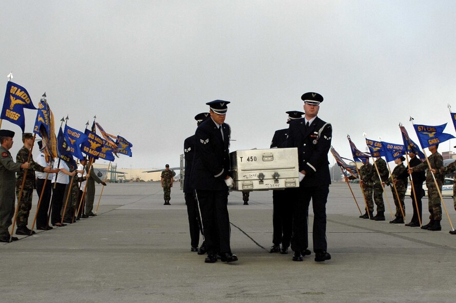 TRAVIS AIR FORCE BASE, Calif. (AMCNS) -- Members of the Travis AFB Honor Guard escort the remains of a person believed to be a servicemember to a KC-10 during a dignified transfer Oct. 24. The remains were transported to the Central Identification Laboratory in Hawaii. (Photo by Airman 1st Class Tiffany Low)