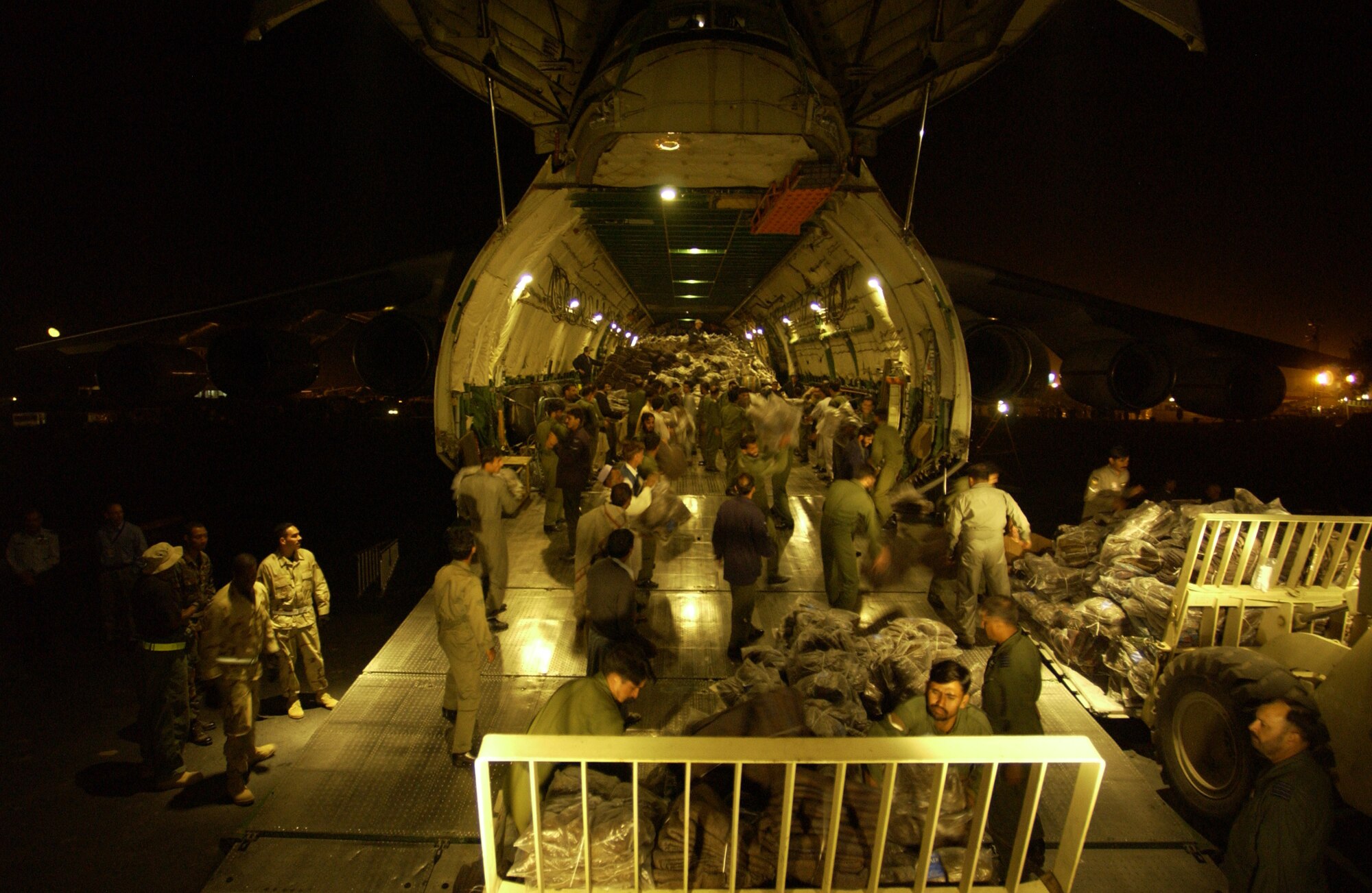 United States Air Force Airman, Pakistani soldiiers, and Ukrainian aid works offload a Russian AN-225 full of floor loaded blanks at Chaklala Air Base, Pakistan, Oct. 21, 2005.  The United States government is participating in a multinational humanitarian assistance and support effort lead by the Pakistani Government to bring aid to victims of the devastating earthquake that struck the region Oct 8, 2005. (US Air Force photo by: Tech. Sgt Jeromy K. Cross) (released)  
