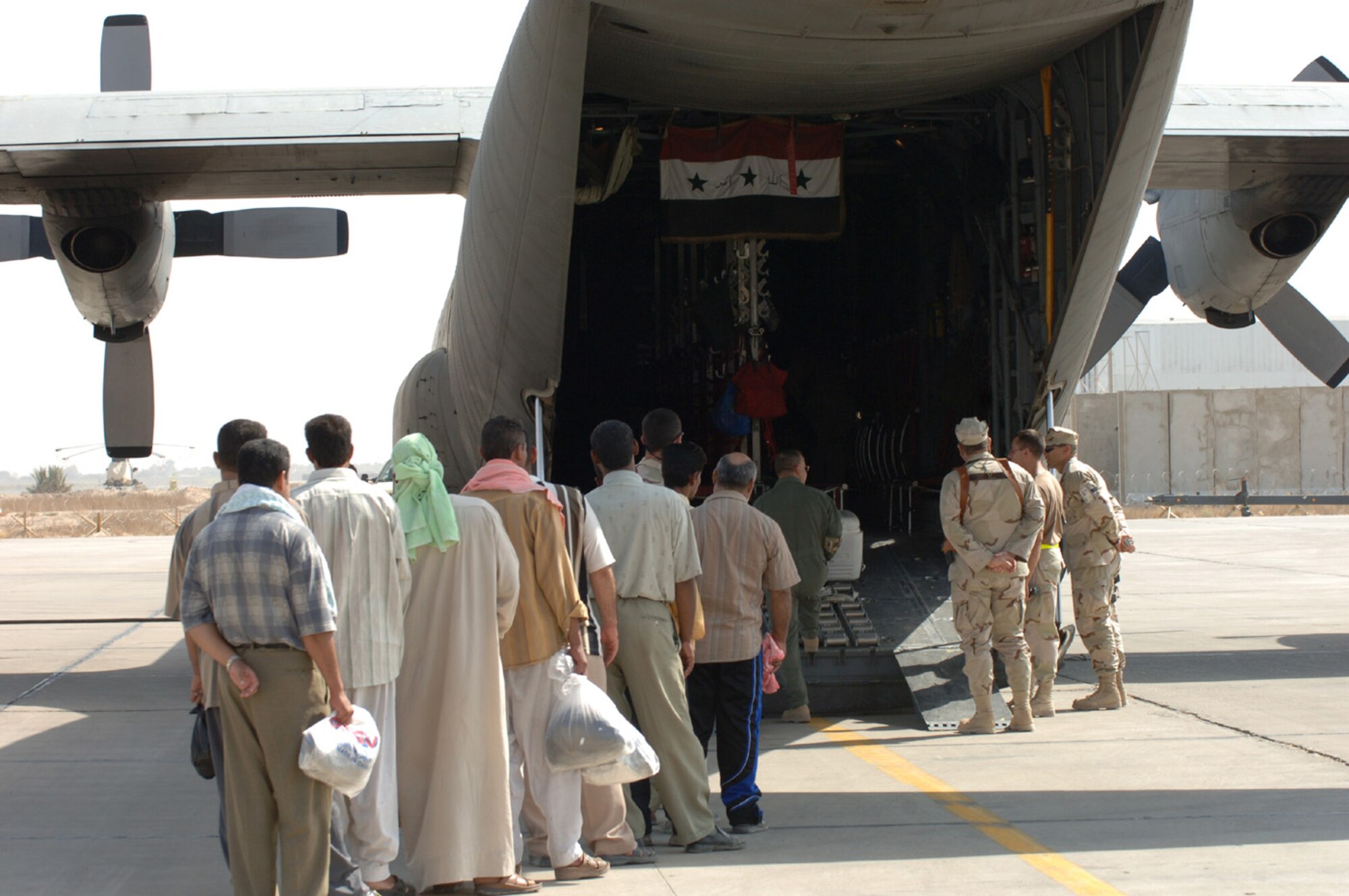 SATHER AIR BASE, Iraq (AMCNS) -– Iraqi poll workers board an Iraqi Air Force C-130 en route to their respective polling stations. (Photo by Master Sgt. Randy L. Mitchell)