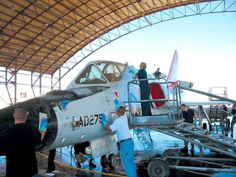 EDWARDS AIR FORCE BASE, Calfi. (AFPN) -- Volunteers scrub an F-106 Delta Dart in preparation for restoration. The jet was displayed at the open house and air show, and will eventually be part of a century series fighter display here at the West Gate. (U.S. Air Force photo by Maj. Matt Humes) 