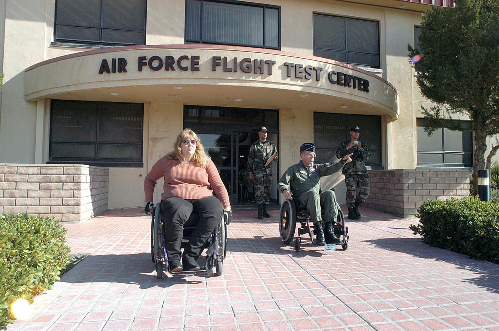 EDWARDS AIR FORCE BASE, Calif. (AFPN) -- Maj. Gen. Curtis Bedke, Air Force Flight Test Center commander (right), and Donna Smith, 412th Test Wing engineering directorate senior resource advisor, take an outing together to experience the difficulties being in a wheelchair when accomplishing daily activities. (U.S. Air Force photo by Senior Airman Jet Fabara) 
