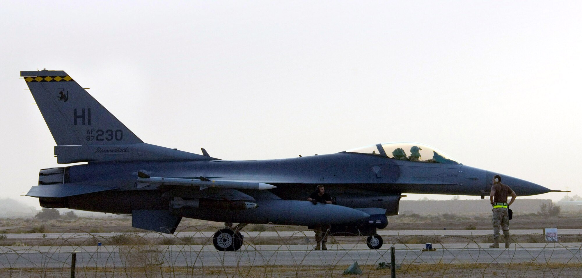 BALAD AIR BASE, Iraq (AFPN) -- An F-16 Fighting Falcon awaits takeoff here. The aircraft is currently supporting Operation Iraqi Freedom. The F-16 Fighting Falcon is a compact, multi-role fighter aircraft. It is highly maneuverable and has proven itself in air-to-air combat and air-to-surface attack. It provides a relatively low-cost, high-performance weapon system for the United States and allied nations. (U.S. Air Force photo by Master Sgt. John E. Lasky)