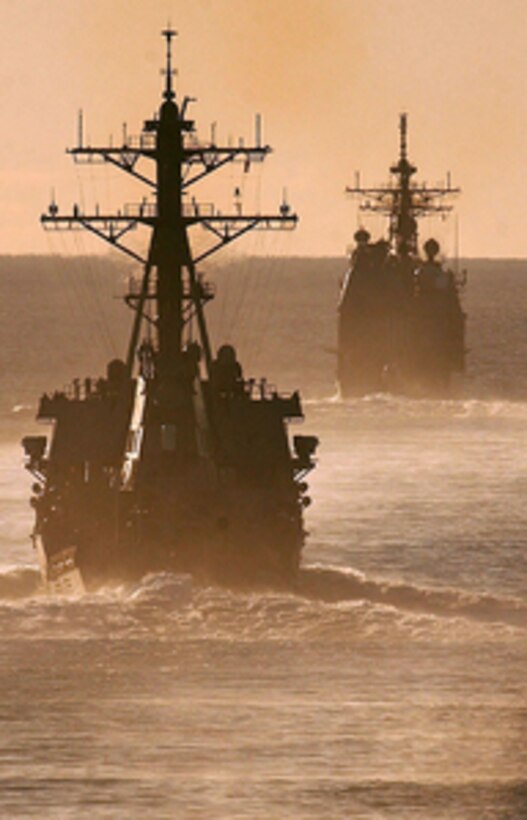 The guided-missile destroyer USS Decatur (left) (DDG 73) follows the cruiser USS Lake Champlain (CG 57) during maneuvers off the coast of Southern California on Oct. 29, 2005. Both ships are part of Commander, Carrier Strike Group 7 and are undergoing their composite unit training with the Nimitz-class nuclear powered aircraft carrier USS Ronald Reagan (CVN 76) in the Pacific Ocean. 