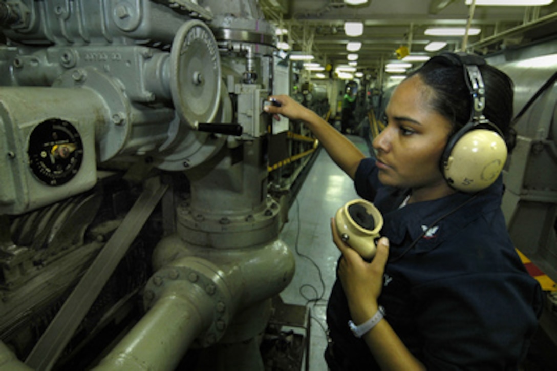 Navy Petty Officer 3rd Class Shantell Robinson monitors arresting gear pressure gauges aboard the aircraft carrier USS Kitty Hawk (CV 63) during flight operations in the Pacific on Oct. 26, 2005. Kitty Hawk's arresting gears control the recovery of aircraft landing on the flight deck, bringing them to a halt within 120 feet. Robinson, of New Orleans, La., is a Navy aviation boatswain's mate onboard the carrier. 