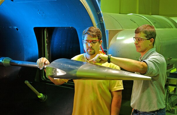 ARNOLD AIR FORCE BASE, Tenn. (AFPN) -- Test engineers Joe Norris (left) and John Lafferty ready a Hypersonic Technology Vehicle-1 model prior to a Hypervelocity Wind Tunnel 9 operation. (U.S. Air Force photo)