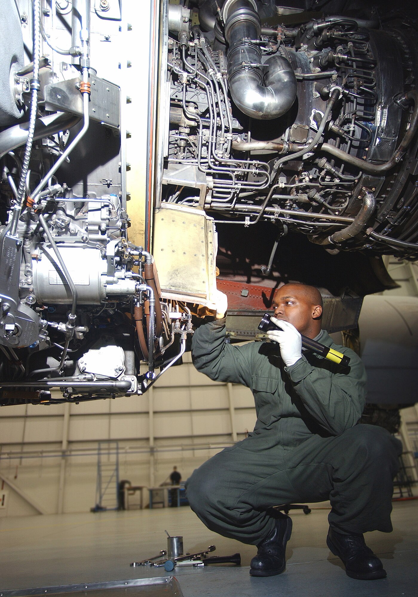 ROYAL AIR FORCE MILDENHALL, England (AFPN) -- Staff Sgt. Chris Canada shines a flashlight on hidden areas of a KC-135 Stratotanker engine to inspect and assess damage during a routine inspection. All 15 aircraft belong to the 100th Air Refueling Wing, RAF Mildenhall, England, and undergo this inspection regularly. Sergeant Canada is assigned to the 100th Maintenance Squadron here. (U.S. Air Force photo by Staff Sgt. Valerie Smith)