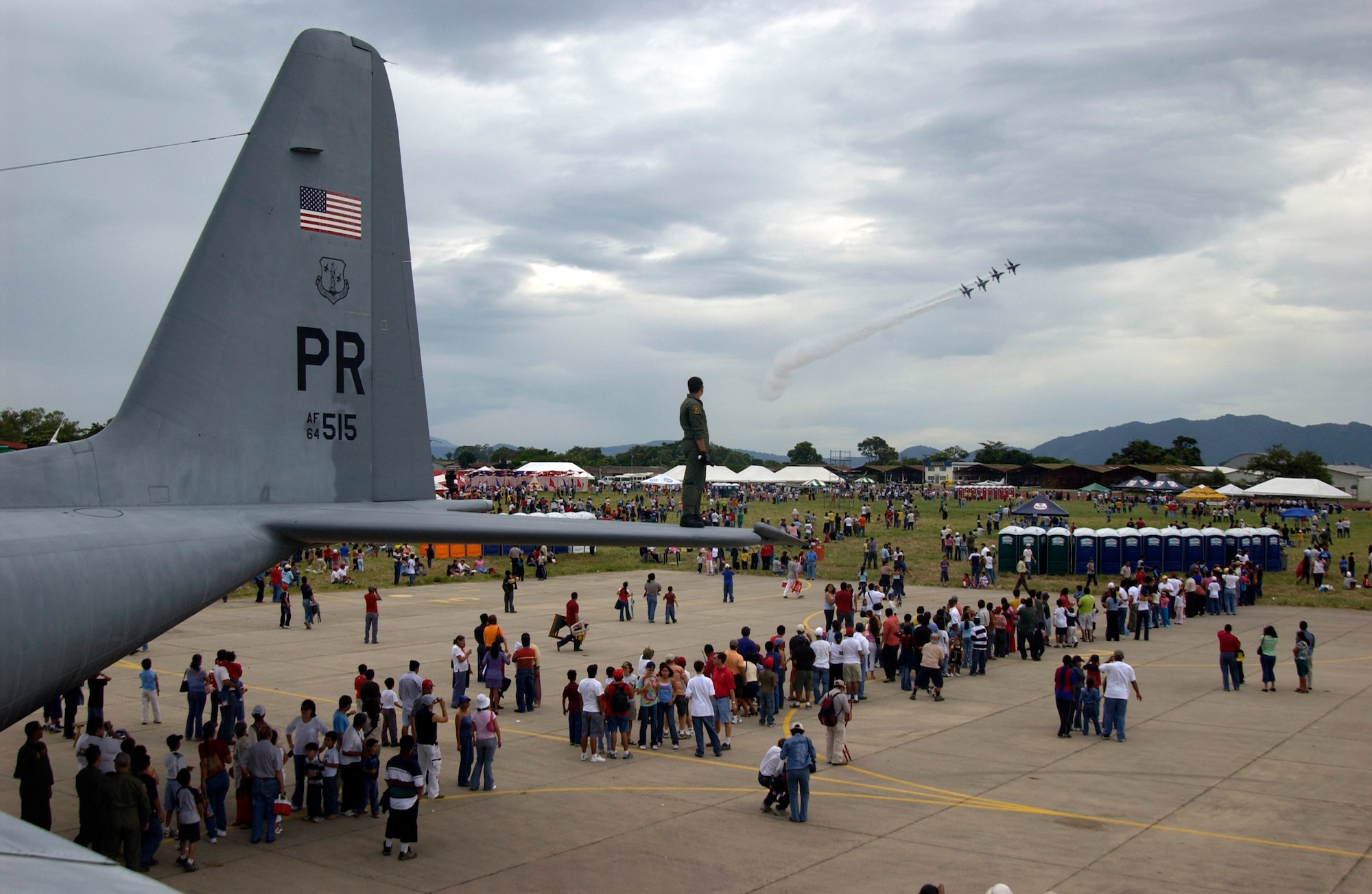 ILOPANGO AIR BASE, El Salvador (AFPN) -- Senior Airman Jean Audiffred, a Puerto Rican Air National Guard C-130 crew chief, observes the Thunderbirds from the tail of his C-130 Hercules during the Ilopango Air Show 2005 in El Salvador. The C-130 was the only U.S. aircraft opened to the public during the Oct. 30 show.  (U.S. Air Force photo by Staff Sgt. Matthew Lohr) 