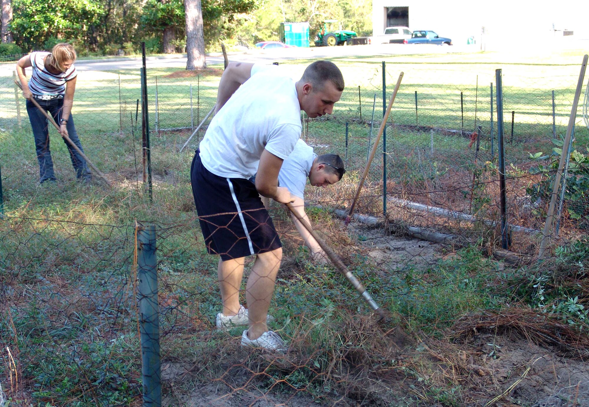 SHALIMAR, Fla. (AFPN) -- Airman Sam Hughes works with other students to clear a community garden plot at the Bob Hope Village here. Residents of Bob Hope and Theresa villages and Eglin Air Force Base's Thrift Shop benefited from the Airmen's labor as they participated in Make A Difference Day Oct. 22 and 28. The day is an annual event, the most encompassing national day of helping others.  Airman Hughes is a Naval School Explosive Ordnance Disposal student. (U.S. Air Force photo by Lois Walsh)