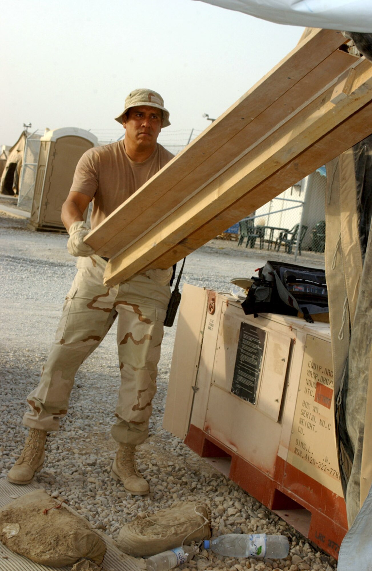 ALI BASE, Iraq (AFPN) -- Tech. Sgt. Ray Urbina takes apart the door frame of a temporary lodging tent to make way for a new services facility.   Sergeant Urbina is assigned to the 407th Expeditionary Civil Engineer Squadron.  (U.S. Air Force photo by Tech. Sgt. Paul Dean)