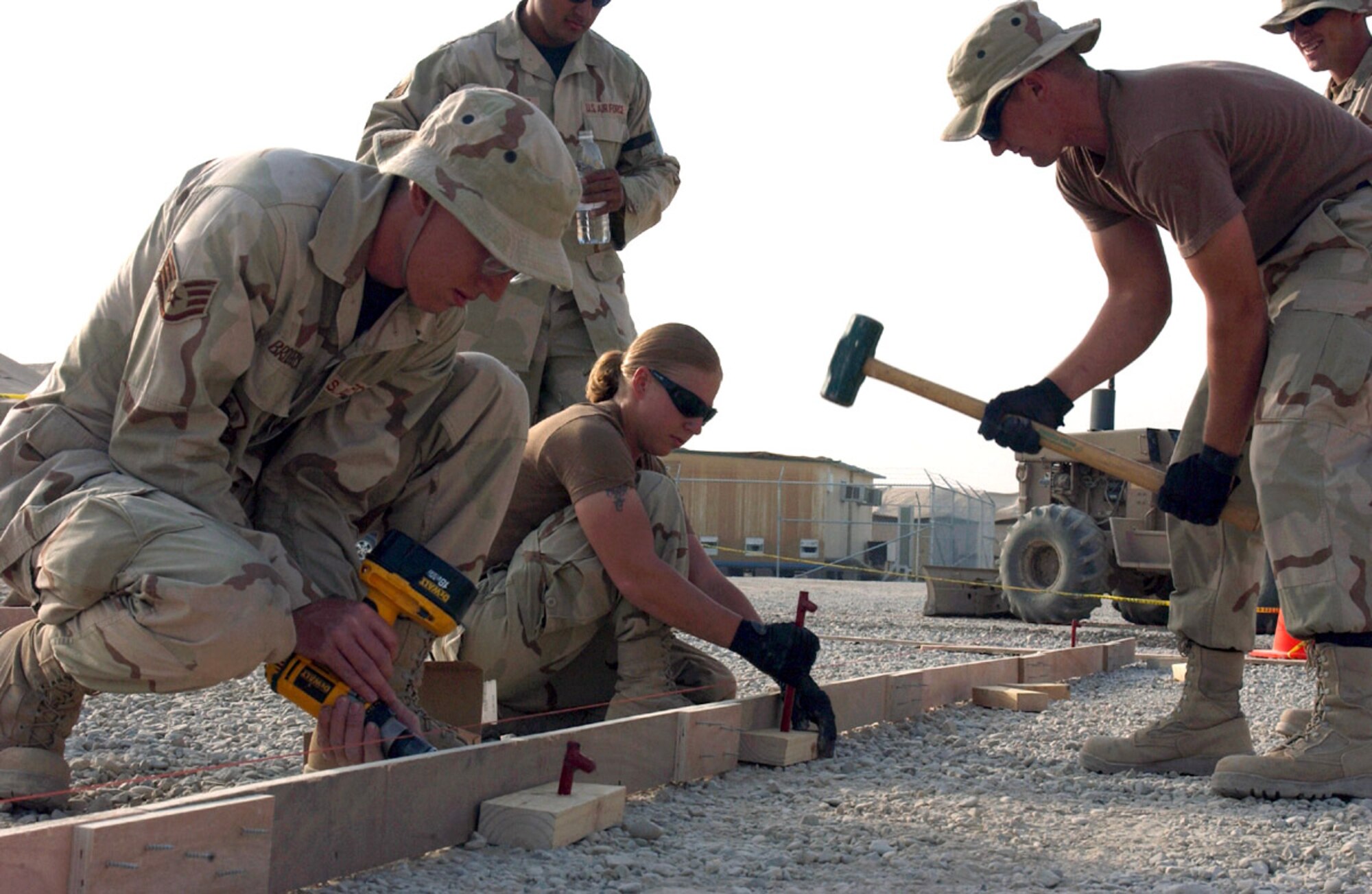 ALI BASE, Iraq (AFPN) -- Airmen from the 407th Expeditionary Civil Engineer Squadron are building concrete forms for a new aerobics area here.  The work is part of a new services facility project. (U.S. Air Force photo by Tech. Sgt. Paul Dean)