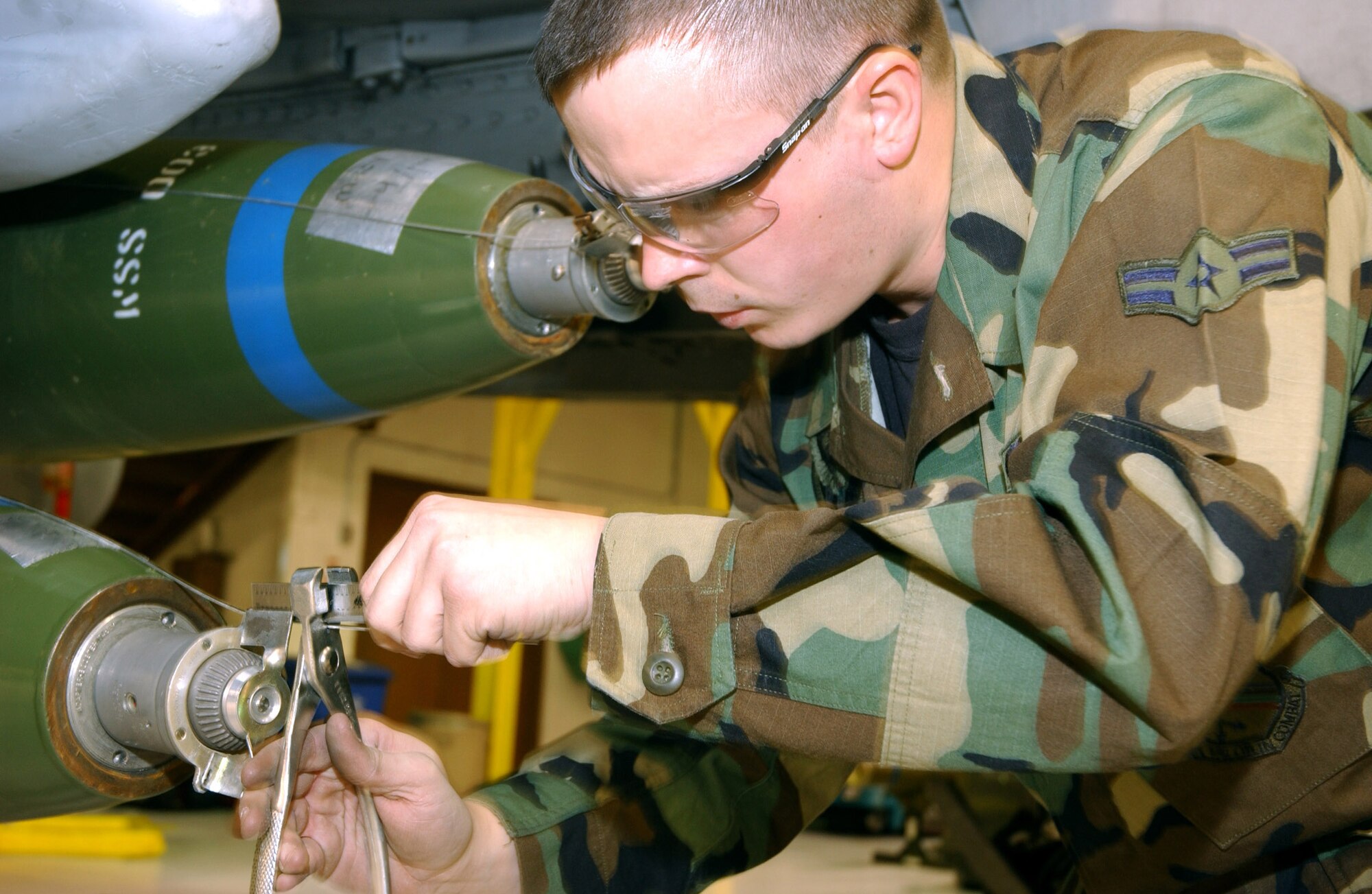 EIELSON AIR FORCE, Alaska (AFPN) -- Airman 1st Class Justin Martin cuts landers wire to an MK-82 bomb during a quarterly load crew competition here.  Each team of F-16 Fighting Falcon and A-10 Thunderbolt II weapon loaders is evaluated in timeliness and accuracy of loading munitions. Airman Martin is a weapons loader assigned to the 354th Aircraft Maintenance Squadron. (U.S. Air Force photo by Airman 1st Class Anthony Nelson Jr.)