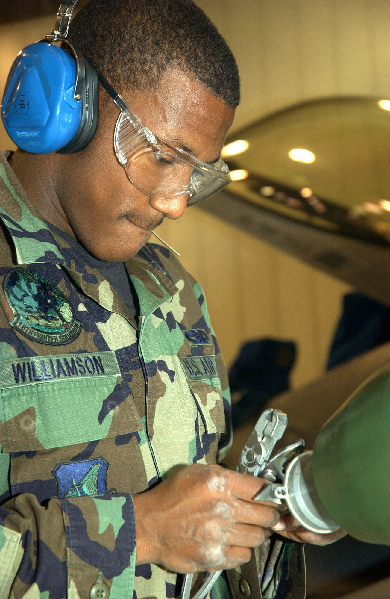 EIELSON AIR FORCE, Alaska (AFPN) -- Airman Brandon Williamson cuts a lanyard off of an MK-82 500-pound bomb during a quarterly load crew competition here.  Each team of F-16 Fighting Falcon and A-10 Thunderbolt II weapon loaders is evaluated in timeliness and accuracy of loading munitions. Airman Williamson is a weapons loader assigned to the 354th Aircraft Maintenance Squadron. (U.S. Air Force photo by Airman 1st Class Anthony Nelson Jr.)