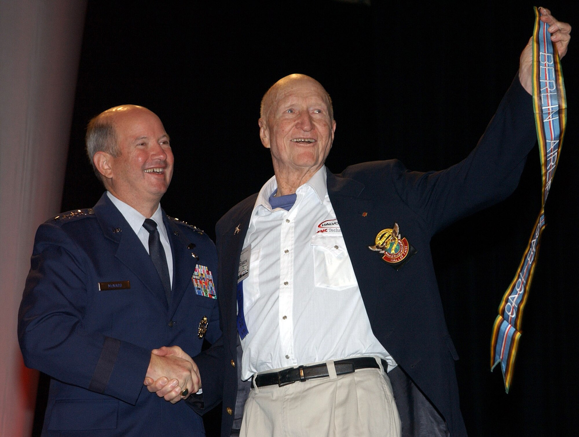 NASHVILLE, Tenn. -- Retired Col. Gail Halvorsen holds the newly authorized Berlin Airlift streamer after Gen. Duncan J. McNabb presented it to him Oct. 29 here at the Airlift Tanker Association convention. Units that  participated in the 1948-1949 humanitarian airlift can include the streamer on their units' guidons. Colonel Halvorsen is known as the "Candy Bomber" for dropping candy from his aircraft to German children during the airlift. (U.S. Air Force photo)
