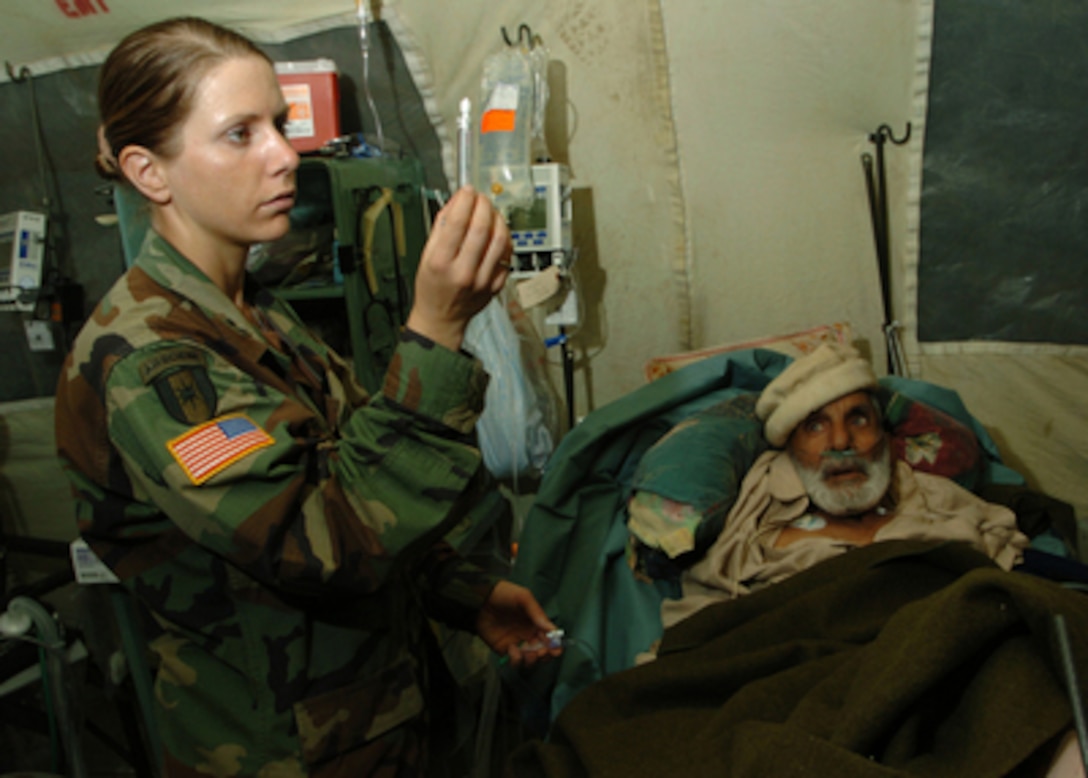 U.S. Army Capt. Kristen Hyer checks a medication before administering it to a Pakistani man in Muzafarrabad, Pakistan, on Oct. 30, 2005. Hyer is a registered nurse assigned to the 212th Mobile Army Surgical Hospital. The Department of Defense is supporting the State Department by providing disaster relief supplies and services following the massive earthquake that struck Pakistan and parts of India and Afghanistan. 