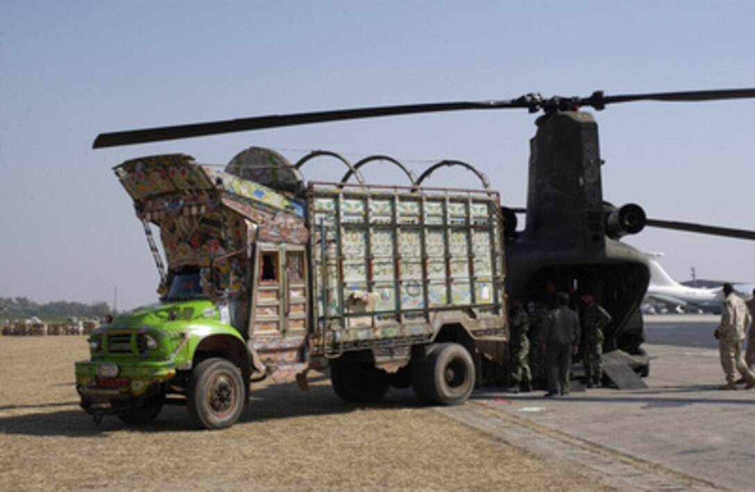 Pakistani soldiers load food, blankets, and other humanitarian relief supplies into a U.S. Army CH-47D Chinook at Chaklala Air Base, Pakistan, on Nov. 1, 2005. The Chinook will deliver the supplies to a remote location in Pakistan. The Department of Defense is supporting the State Department by providing disaster relief supplies and services following the massive earthquake that struck Pakistan and parts of India and Afghanistan. 
