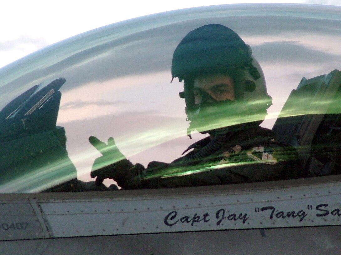 SIALULIAI, Lithuania (AFPN) -- Capt. Joey Gaona signals the completion of another successful mission here. The 23rd Expeditionary Fighter Squadron is participating in NATO's Baltic Air Policing mission, providing 24-hour security over the skies of Lithuania, Latvia and Estonia.  Captain Gaona is an F-16 Fighting Falcon pilot assigned to the 23rd Fighter Squadron at Spangdahlem Air Base, Germany. (U.S. Air Force photo by Capt. Thomas Crosson) 