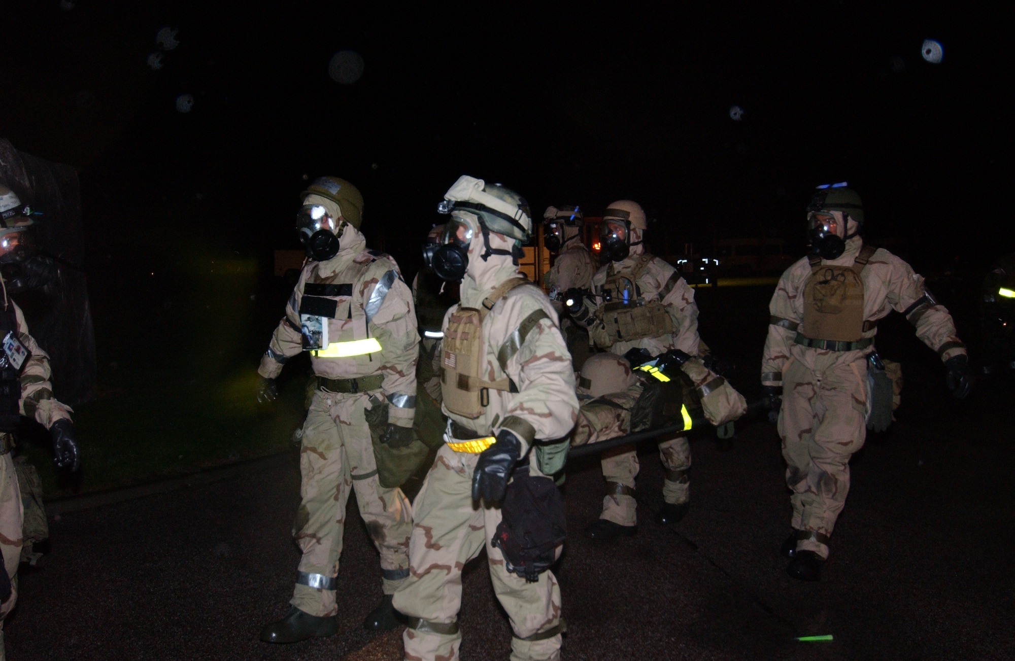 Members of the 352nd Special Operations Group perform a litter drill in full chemical warfare ensemble. The Ability to Survive and Operate is a major graded portion of the inspection. 