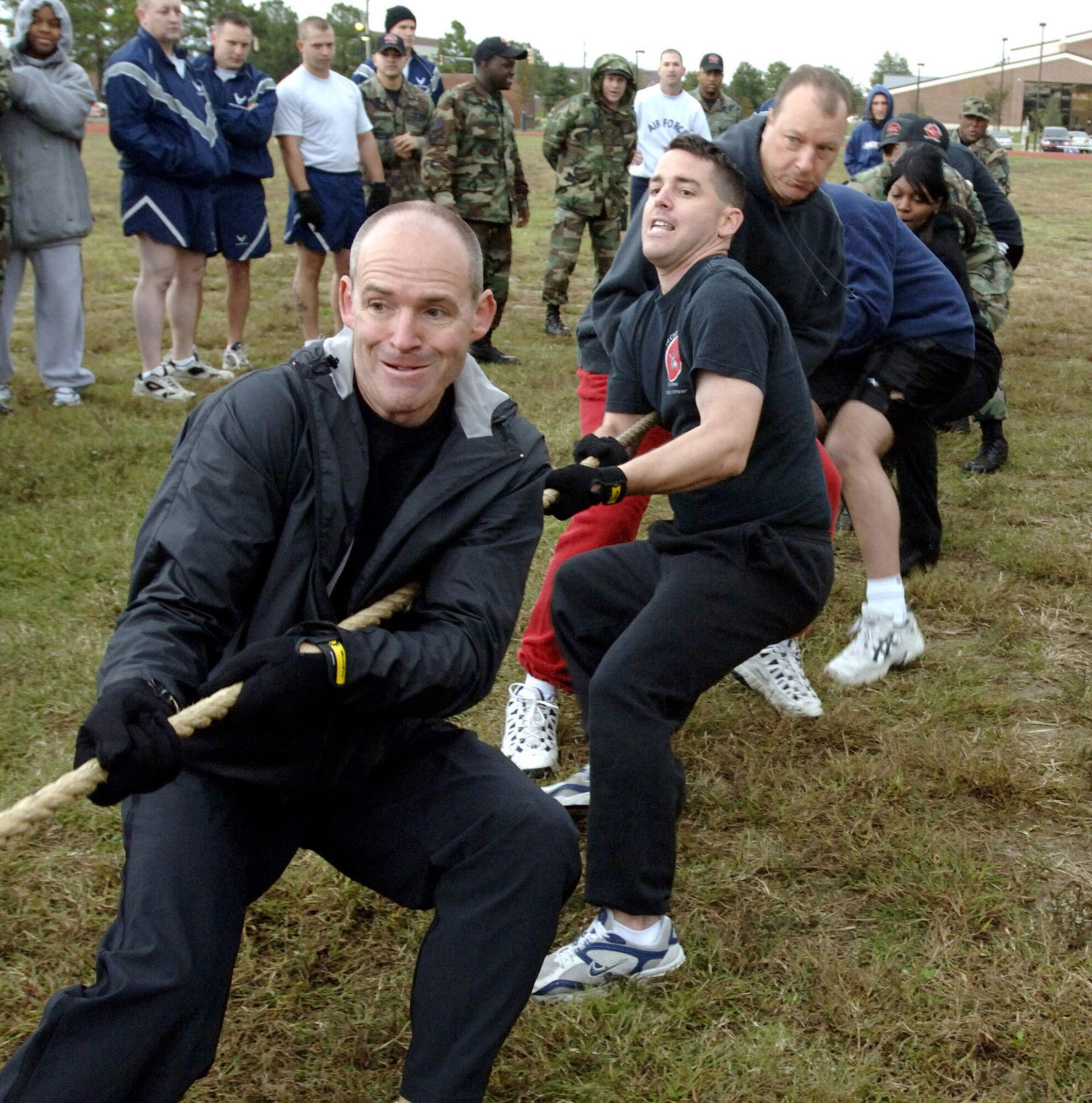 LANGLEY AIR FORCE BASE, Va. (AFPN) -- Lt. Col. Gregory Perkinson (left) is followed by Capt. David Hern and Chief Master Sgt. Timothy Prentice during the tug-of-war competition here during the base fitness challenge.  The 1st Mission Support Group held a challenge testing each squadron's abilities at push-ups, sit-ups, running and tug-of-war.  (U.S. Air Force photo by Airman 1st Class Christopher Ingersoll) 