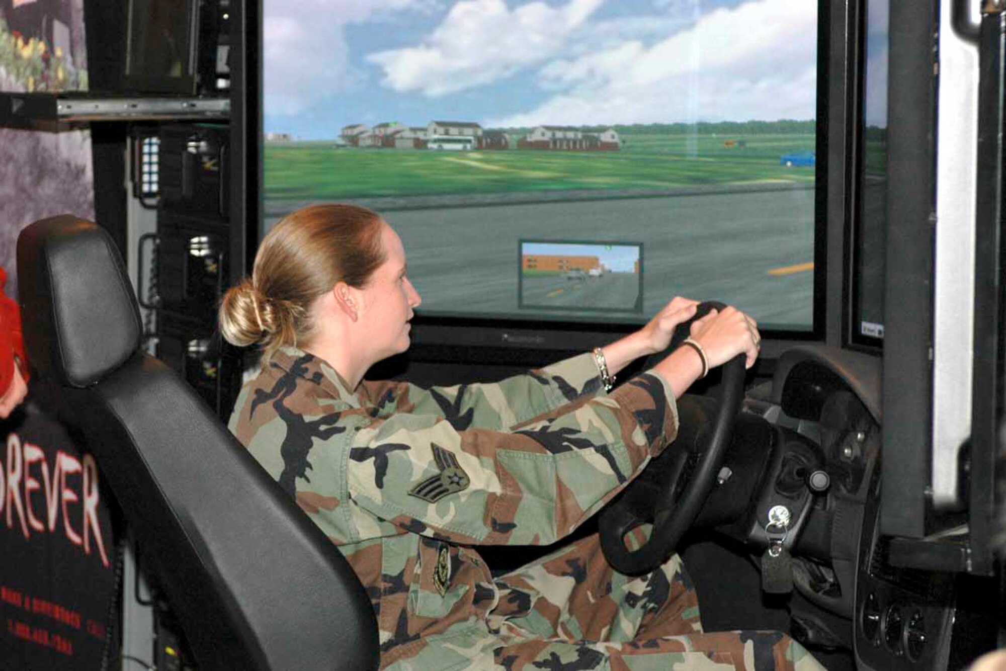 TRAVIS AIR FORCE BASE, Calif. (AFPN) -- Senior Airman Jacqueline Johns drives the drunk-driving simulator. The simulator is part of the Save-A-Life tour and gives people a first-hand experience of driving under the influence. Airman Johns is assigned to the 60th Air Mobility Wing Command Post. (U.S. Air Force photo by Airman 1st Class Tiffany Low)