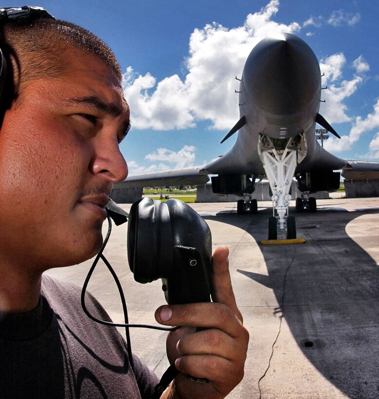ANDERSEN AIR FORCE BASE, Guam -- Senior Airman Kendal Lizama talks to pilots during preflight checks. Six B1-B Lancers and nearly 200 people deployed here from the 28th Bomb Wing from Ellsworth AFB, S.D.  Airman Lizama is a crew chief with the 36th Expeditionary Maintenance Squadron.  (U.S. Air Force photo by Staff Sgt. Bennie J. Davis III)